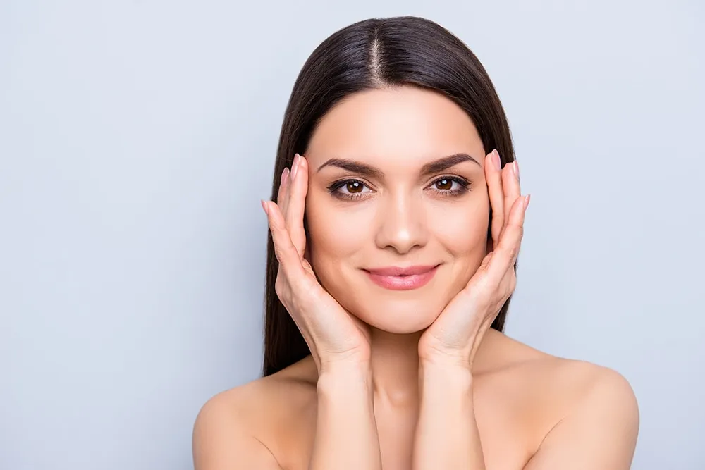 woman touching her face
