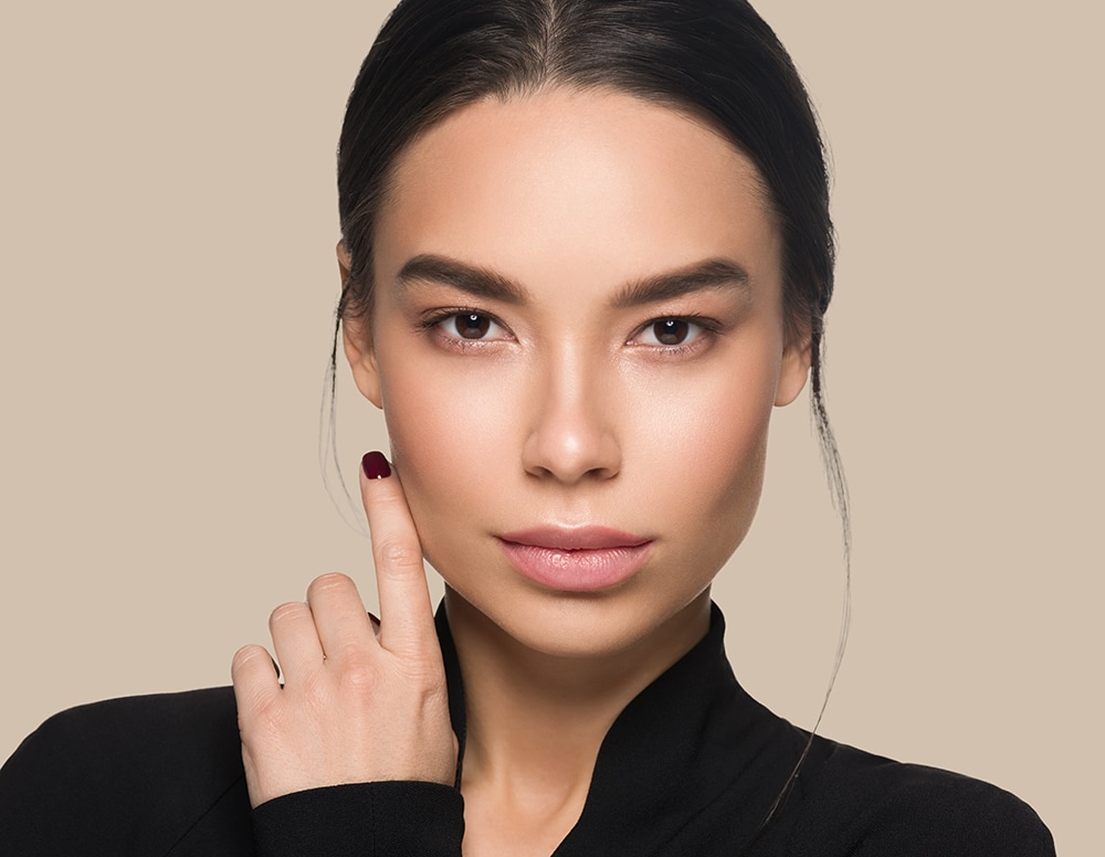 woman touching her face